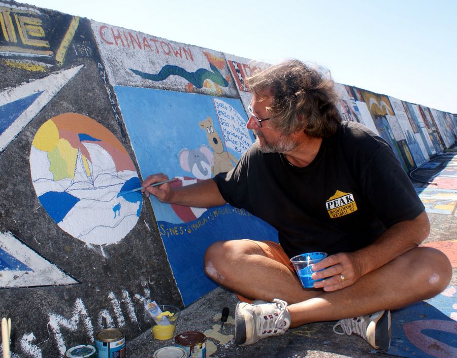 John painting our logo on the wall